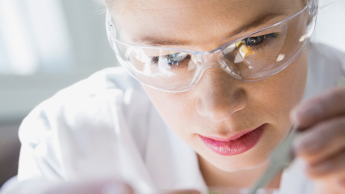 Close-up of a female scientist wearing protective glasses
